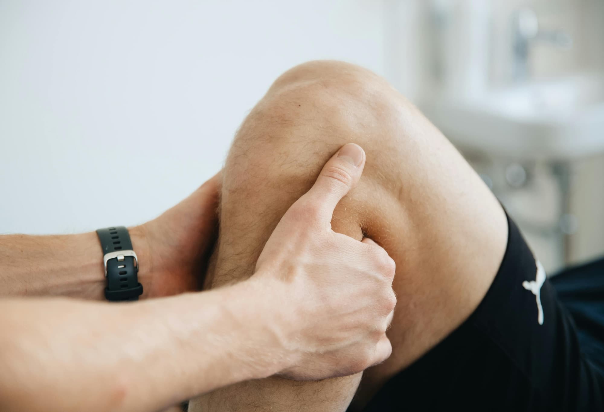 Physio working on an athlete's knee